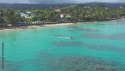 Tourusts have fun on motorboat at Playa Punta Popy, Las Terrenas in Dominican Republic. Aerial view photo