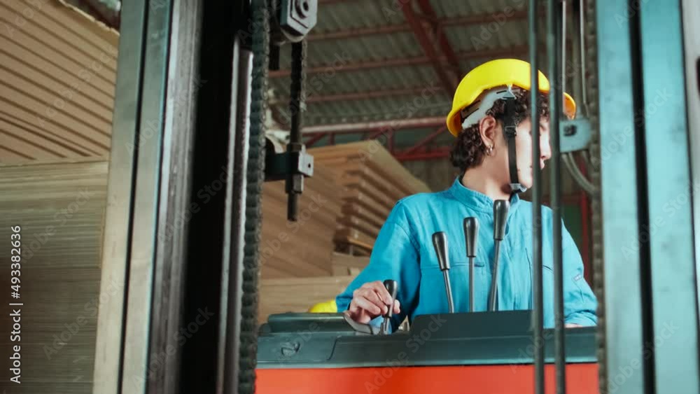 Industry factory female workers in safety uniform and hard hat inspect storage by laptop, stock order at warehouse, management piles of stacking cardboard with forklift, manufacture product logistic. Industry factory female workers in safety uniform and hard hat inspect storage by laptop, stock order at warehouse, management piles of stacking cardboard with forklift, manufacture product logistic.