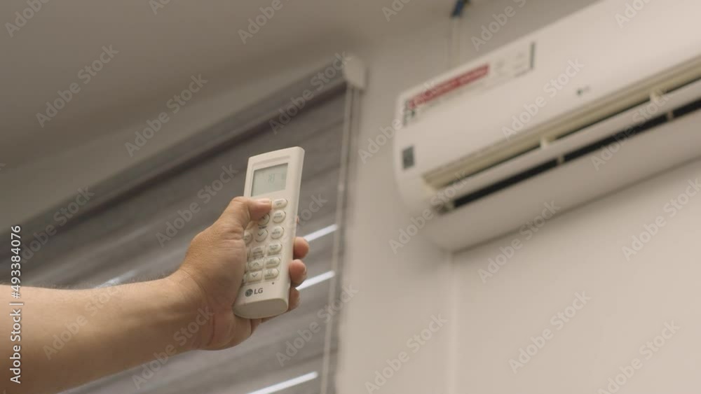 Pointing An Aircon Remote Control And Turning It On Pointing An Aircon Remote Control And Turning It On