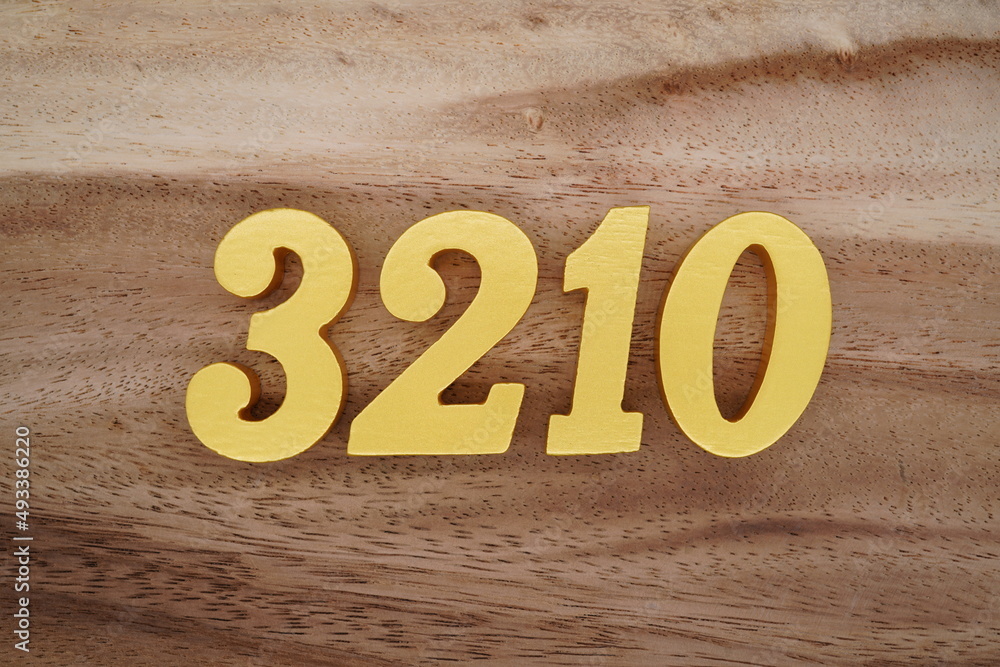 Golden Arabic numerals on a real brown and white wooden floor number ...