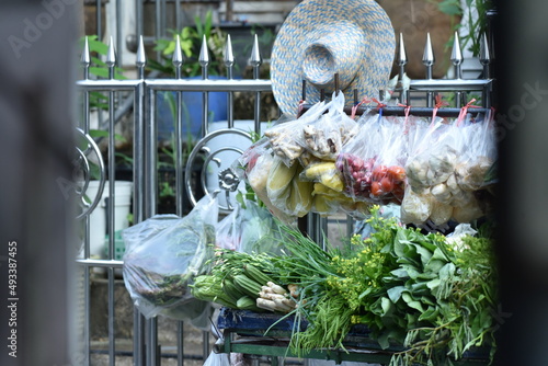 A variety of fresh food in plastic bags hung on carts for sale.