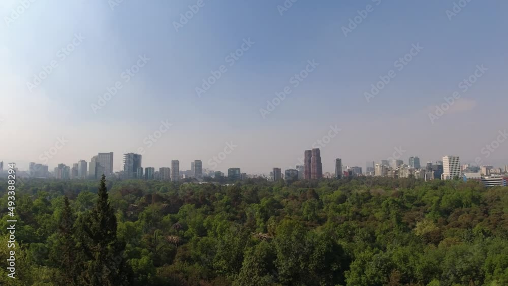 The skyline of Mexico City (CDMX) behind a large, green, wooded park, the Bosque de Chapultepec The skyline of Mexico City (CDMX) behind a large, green, wooded park, the Bosque de Chapultepec