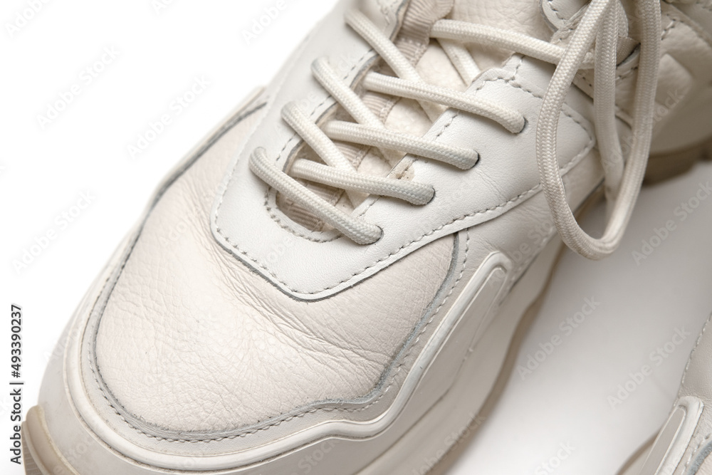 White leather sneakers on a white background. White leather sneakers on a white background.