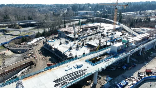 Cinematic 4K aerial drone orbit shot of the Lynnwood Transit Center Park and Ride construction, new Seattle Light Rail station, I-5 freeway with Lynnwood and Mountlake Terrace suburbs nearby photo