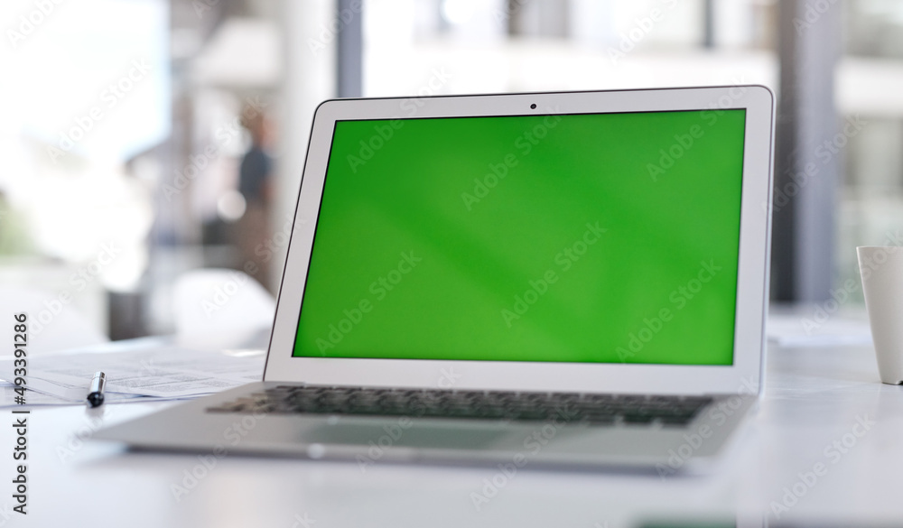 Make sure your landing page makes the loudest statement. Shot of a laptop with a green screen on a desk in a modern office. Make sure your landing page makes the loudest statement. Shot of a laptop with a green screen on a desk in a modern office.