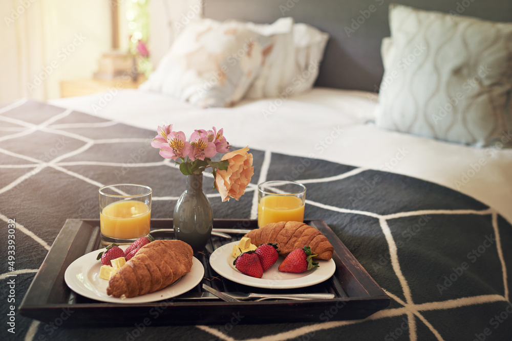 Nothing better than breakfast in bed. Shot of a tray with breakfast on a bed. Nothing better than breakfast in bed. Shot of a tray with breakfast on a bed.