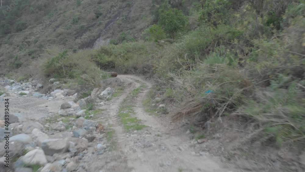 Mountain dirt road vehicle tracks leading out to riverbed opening boulders rocks sand i valley Kabayan Benguet Philippines fast reverse reveal aerial Mountain dirt road vehicle tracks leading out to riverbed opening boulders rocks sand i valley Kabayan Benguet Philippines fast reverse reveal aerial