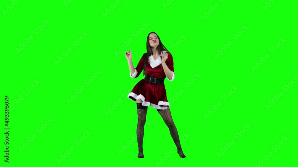Beautiful female dancer dancing in Christmas costume in front of a green screen Beautiful female dancer dancing in Christmas costume in front of a green screen