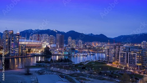 Vancouver, BC British Columbia, Canada Day to Night Timelapse, Downtown looking at Rogers Arena, False Creek and the North Shore Mountains photo