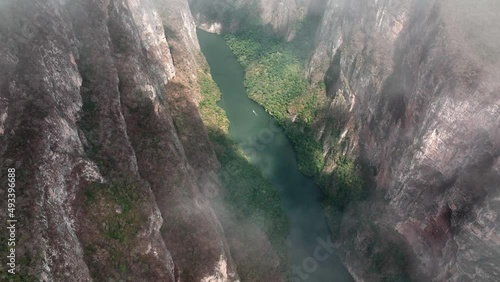 AERIAL - Sumidero Canyon and Grijalva River through clouds, Chiapas, Mexico, reveal photo