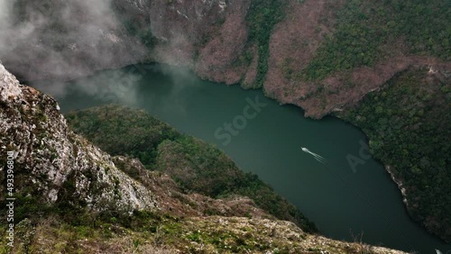 AERIAL - Boat on Grijalva River in Sumidero Canyon, Chiapas, Mexico, spinning shot photo