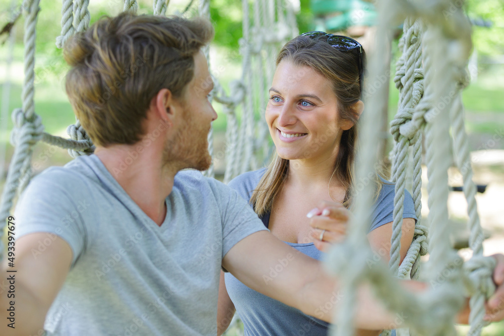 two person climbing a tree in an adventure park two person climbing a tree in an adventure park