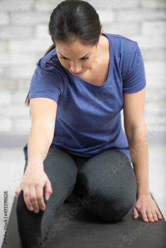 beautiful fitness woman stretching legs at home