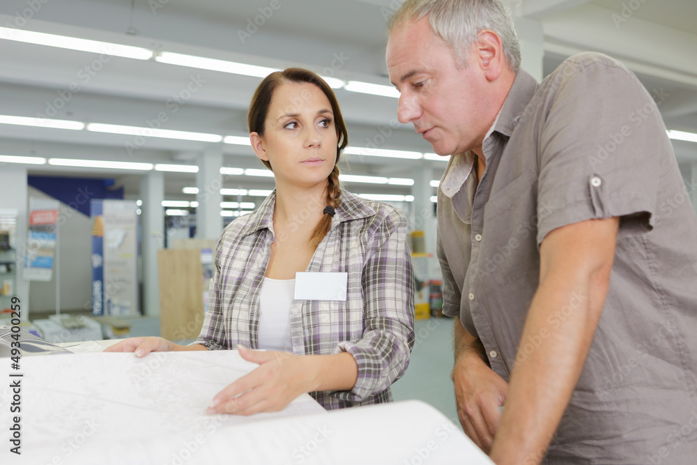man and woman discussing something in store