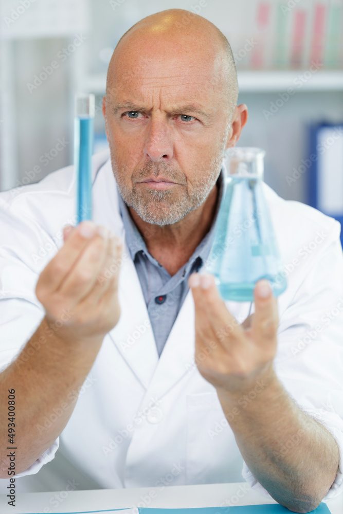 investigator checking test tubes investigator checking test tubes