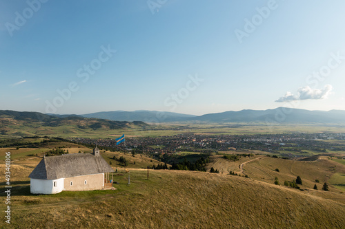 Beautiful Transylvanian landscape. Mountains, Szekler flag, the city of Gheorgheni in the background.