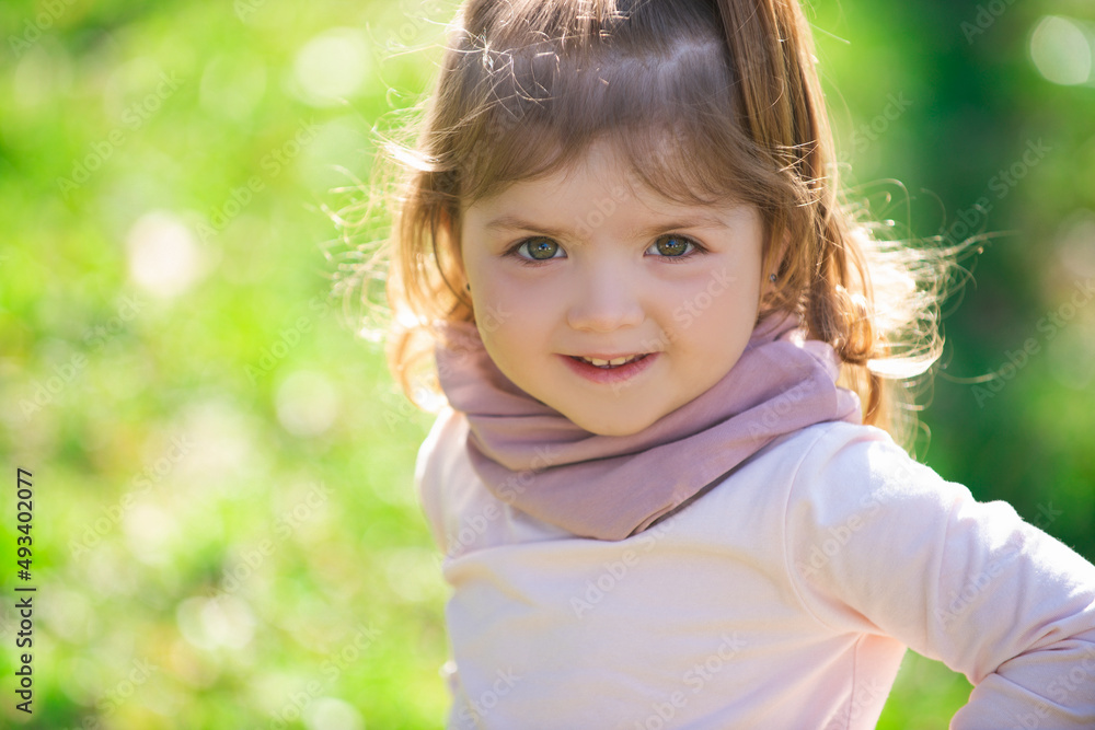 Baby child girl in grass on the fieald at summer. Baby face closeup. Funny little child close up portrait. Blonde kid, smiling emotion face. Baby child girl in grass on the fieald at summer. Baby face closeup. Funny little child close up portrait. Blonde kid, smiling emotion face.