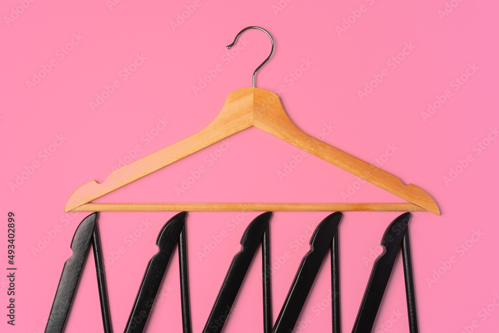 Flat lay composition with empty hangers on pink background Flat lay composition with empty hangers on pink background