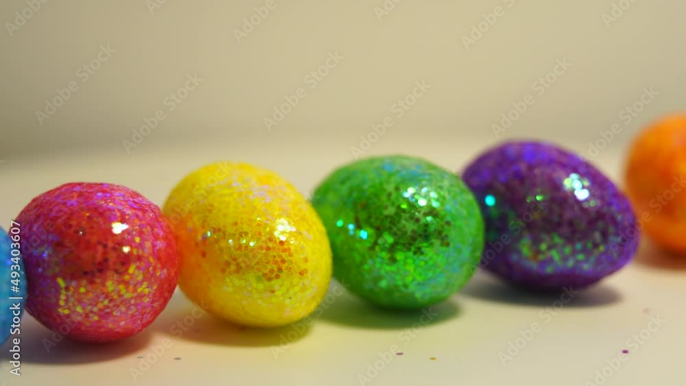 Colorful Easter eggs rotating in rows in a seamless loop on a light background Colorful Easter eggs rotating in rows in a seamless loop on a light background