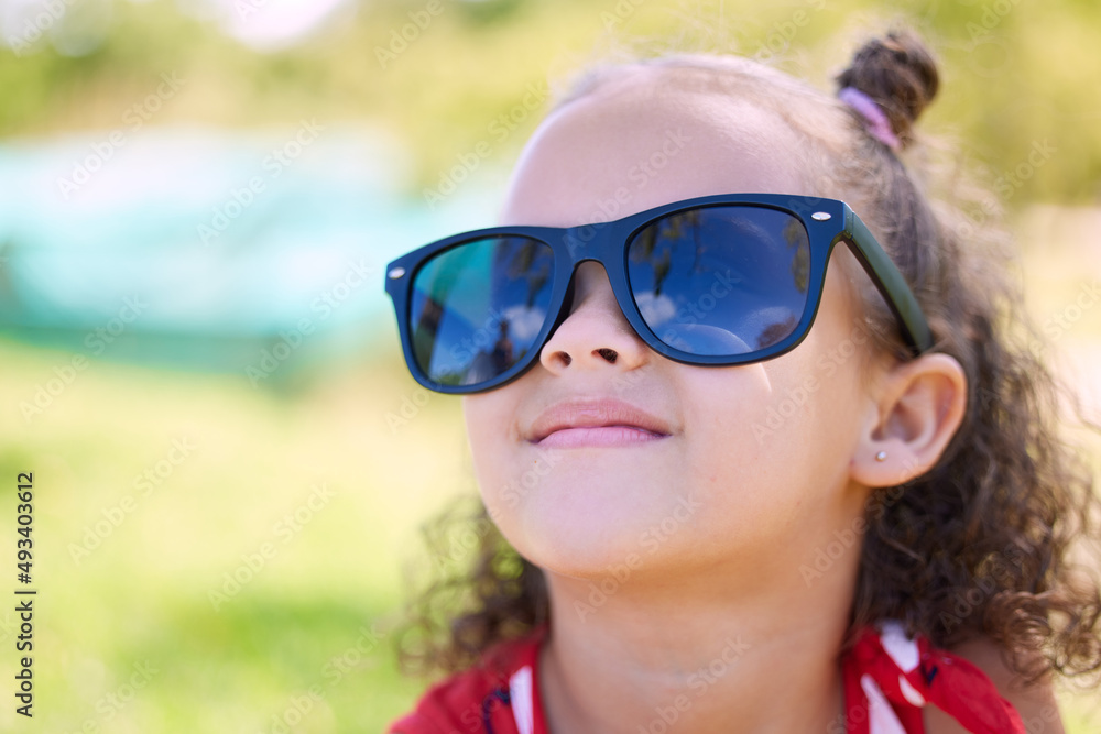 Everyone loves sunny days. Shot of an adorable little girl wearing sunglasses while at the park. Everyone loves sunny days. Shot of an adorable little girl wearing sunglasses while at the park.