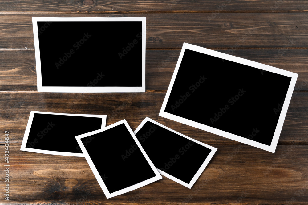 Blank photo frames for your photos on wooden background Blank photo frames for your photos on wooden background