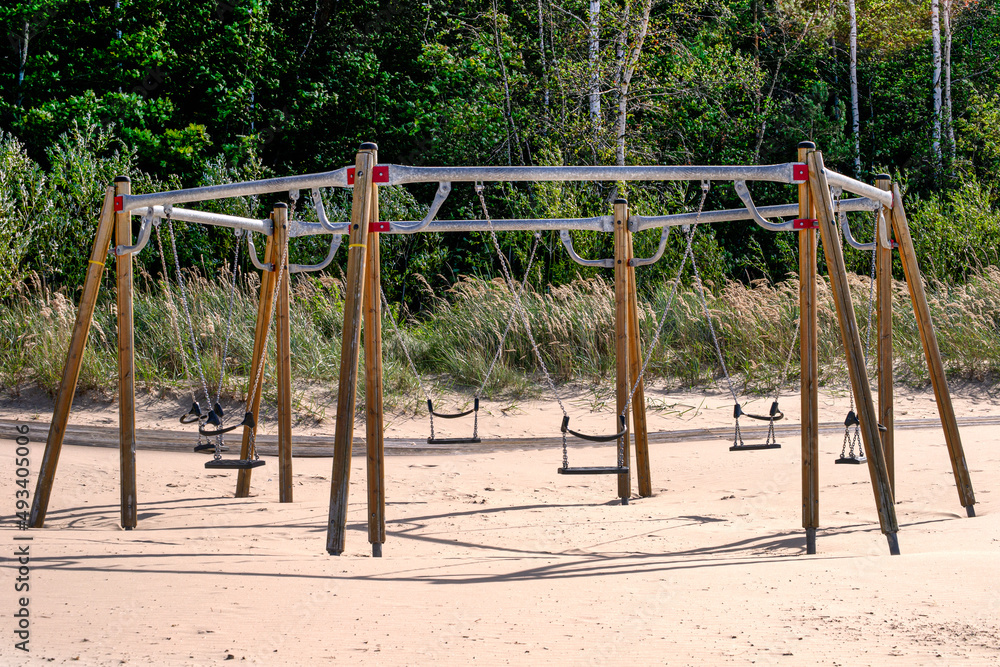 Swing for six places on an empty beach.