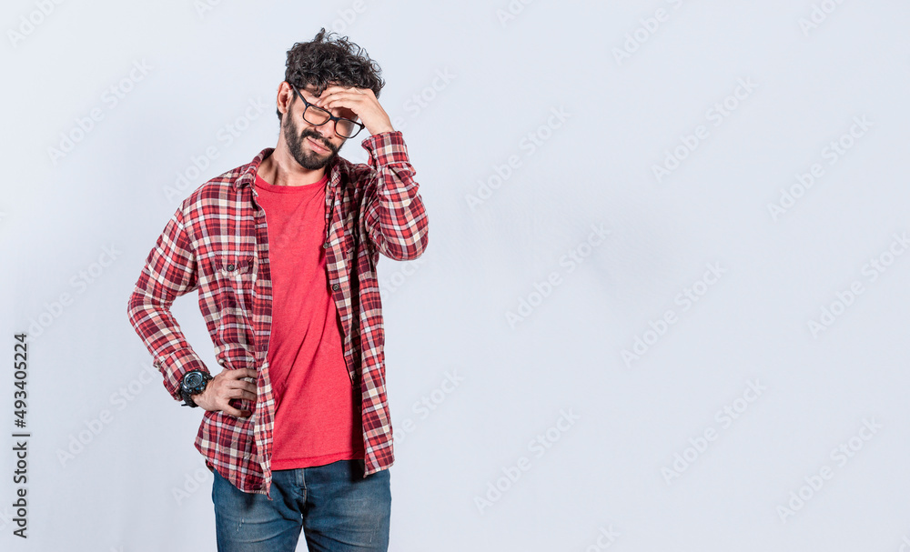 Worried man isolated, worried young man holding his forehead, tired man holding his head, man with headache Worried man isolated, worried young man holding his forehead, tired man holding his head, man with headache