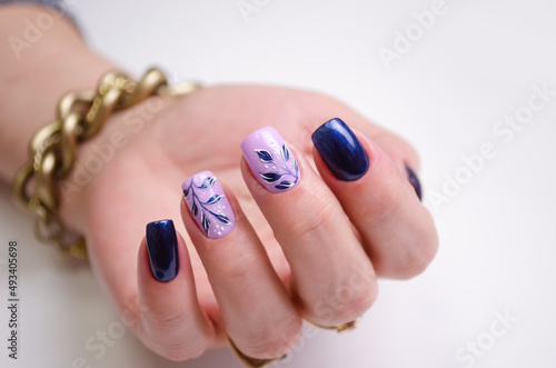 Beautiful female hand with spring manicure on white background