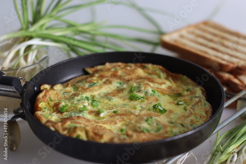 Egg omelette with finely chopped green garlic, green chillies served with butter toasted bread