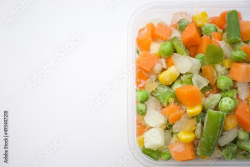 Frozen vegetables. Frozen vegetable mixture of carrots, corn and peas. Collage of different frozen vegetables on white background