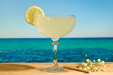 Glass of gimlet cocktail. Summer beach bar.