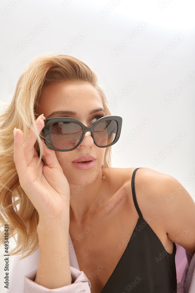 Beauty portrait of elegant attractive blonde woman wearing stylish sunglasses. Fashionable hairstyle. Beauty portrait of elegant attractive blonde woman wearing stylish sunglasses. Fashionable hairstyle.