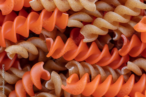 Whole, lentils fusilli pasta background.