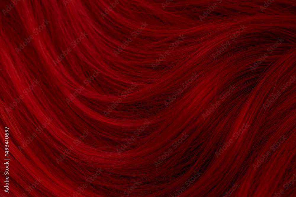 Red hair. Background hair closeup. Female long red-haired close-up as a background. Beautifully laid carroty wavy shiny curls. Hair coloring.Hairdressing procedures. Copy space with space for text. Red hair. Background hair closeup. Female long red-haired close-up as a background. Beautifully laid carroty wavy shiny curls. Hair coloring.Hairdressing procedures. Copy space with space for text.