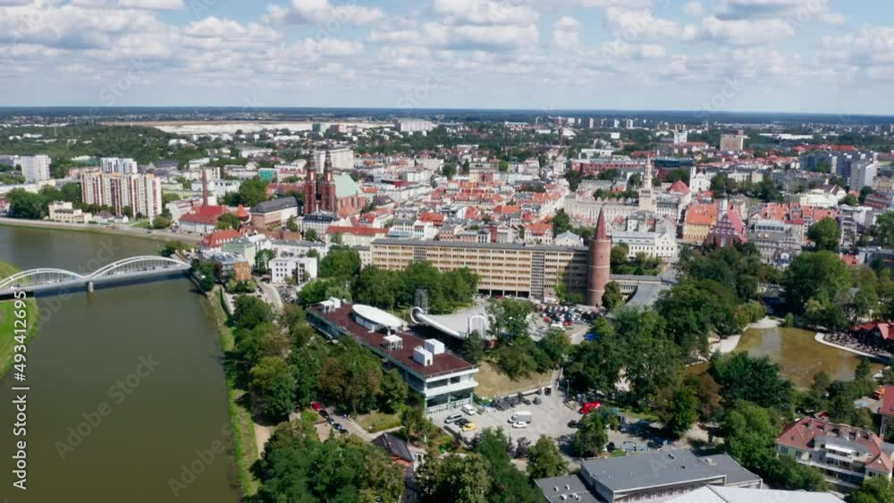 Opole, drone aerial view of Odra river, Piast bridge, Pasieka Island, Wieża Piastowska Piast Tower. Poland, late summer day. Drone real time 4k orbit backward reveal. Opole, drone aerial view of Odra river, Piast bridge, Pasieka Island, Wieża Piastowska Piast Tower. Poland, late summer day. Drone real time 4k orbit backward reveal.