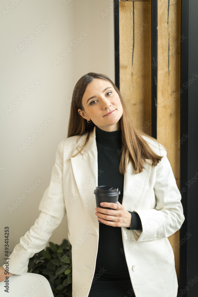 young woman sitting in a cafe at a table