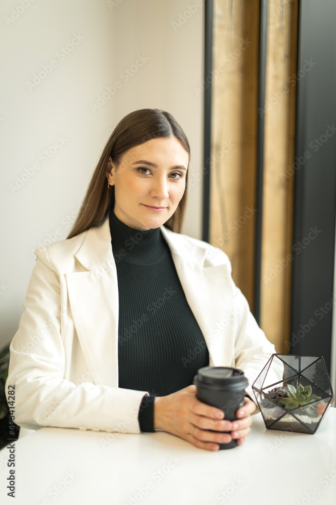 young woman sitting in a cafe at a table