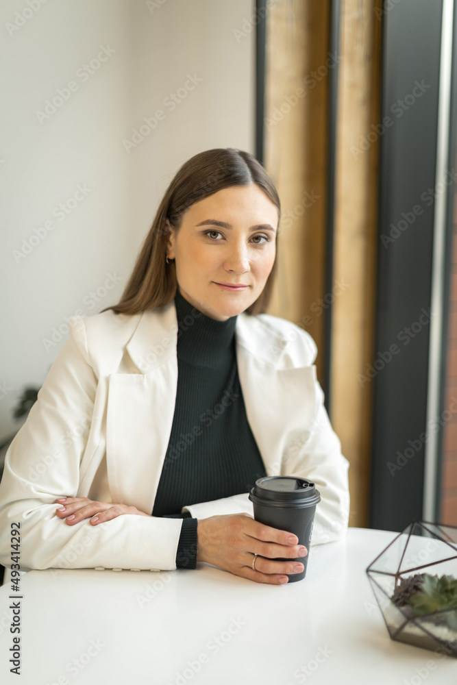 young woman sitting in a cafe at a table