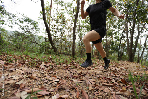 Woman runner running on forest trail © lzf