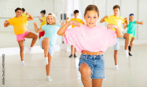 Dance studio - happy girls and boys in dance lesson
