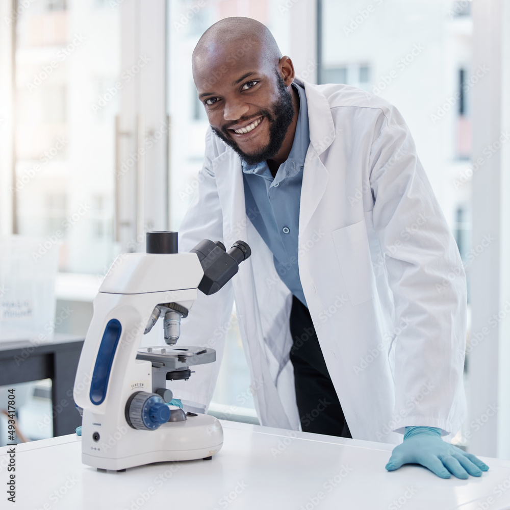 Science and everyday life cannot and should not be separated. Shot of a young scientist using a microscope in a laboratory. Science and everyday life cannot and should not be separated. Shot of a young scientist using a microscope in a laboratory.