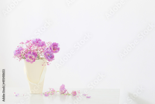 bouquet of pink tulips and gypsophila on white table