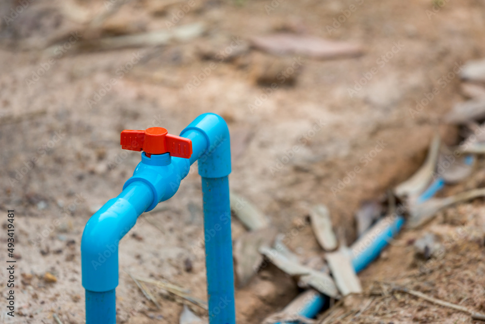 Water valve connect to PVC pipe. valve for agriculture PVC water pipes. Plastic hose and valve of sprinkler system in a garden. Water valve connect to PVC pipe. valve for agriculture PVC water pipes. Plastic hose and valve of sprinkler system in a garden.