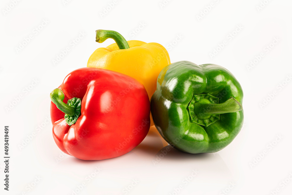 Red yellow and green bell peppers on white background Red yellow and green bell peppers on white background