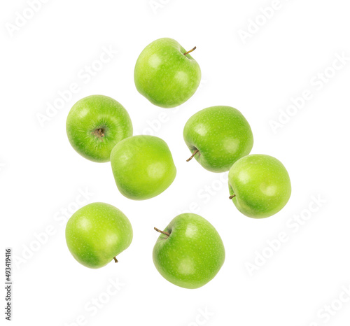 Green apples levitate on white background