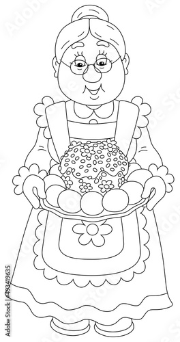 Happy granny with a traditional holiday cake and painted Easter eggs for a festive table, black and white vector cartoon illustration for a coloring book