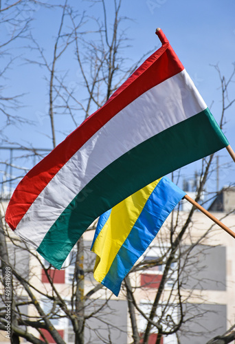 Hungarian and Ukrainian flags against sky