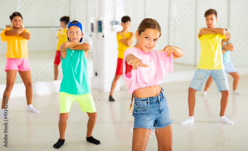 Group of active children dancing hip-hop dance in studio.