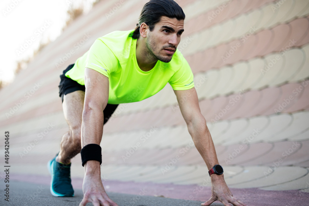 Young muscle man training outside. Fit handsome man doing exercise. Young muscle man training outside. Fit handsome man doing exercise.
