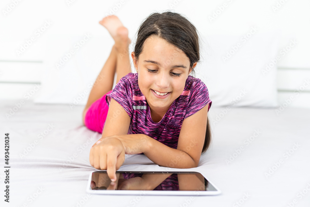 Happy little girl using tablet computer Happy little girl using tablet computer